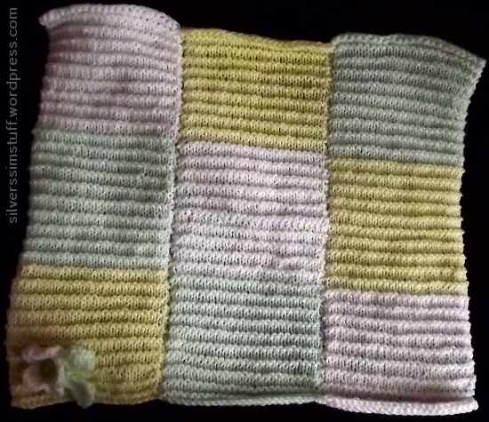 green, yellow and white knitted baby blanket