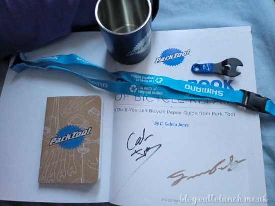 signed big blue book, parktool mug, 10mm spanner keyring and parktool notebook